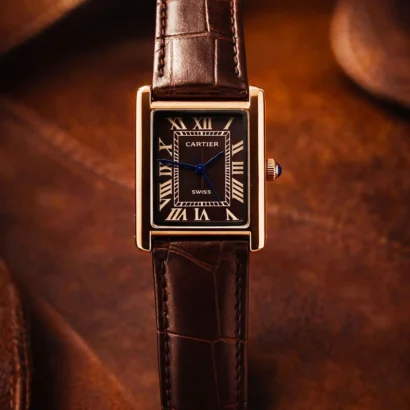 A Cartier Tank–style slim watch with leather strap and classic rectangular case — elegant design at an affordable price.