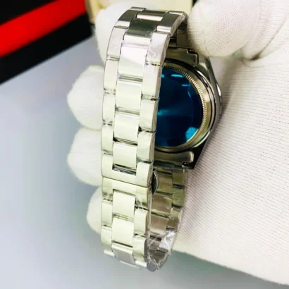 A Rolex-style rainbow stone watch with working date, butterfly lock, and bold luxury look — made for shine, not Swiss horology.